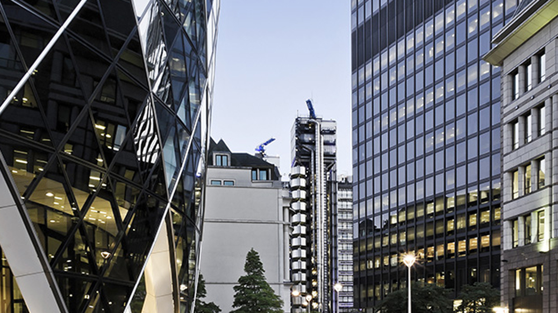 Exterior view of modern office buildings in London with Lloyd's in the distance