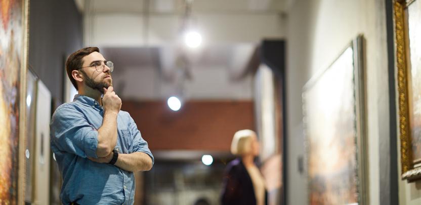 Man looking at art in gallery